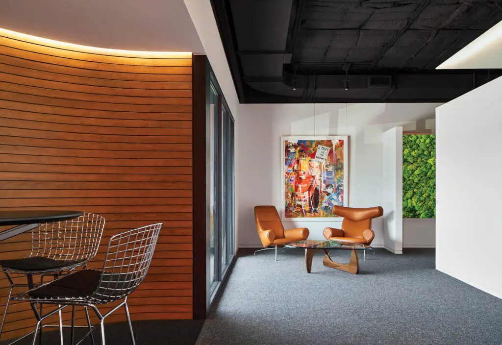 break room area with orange chairs and wooden paneled walls