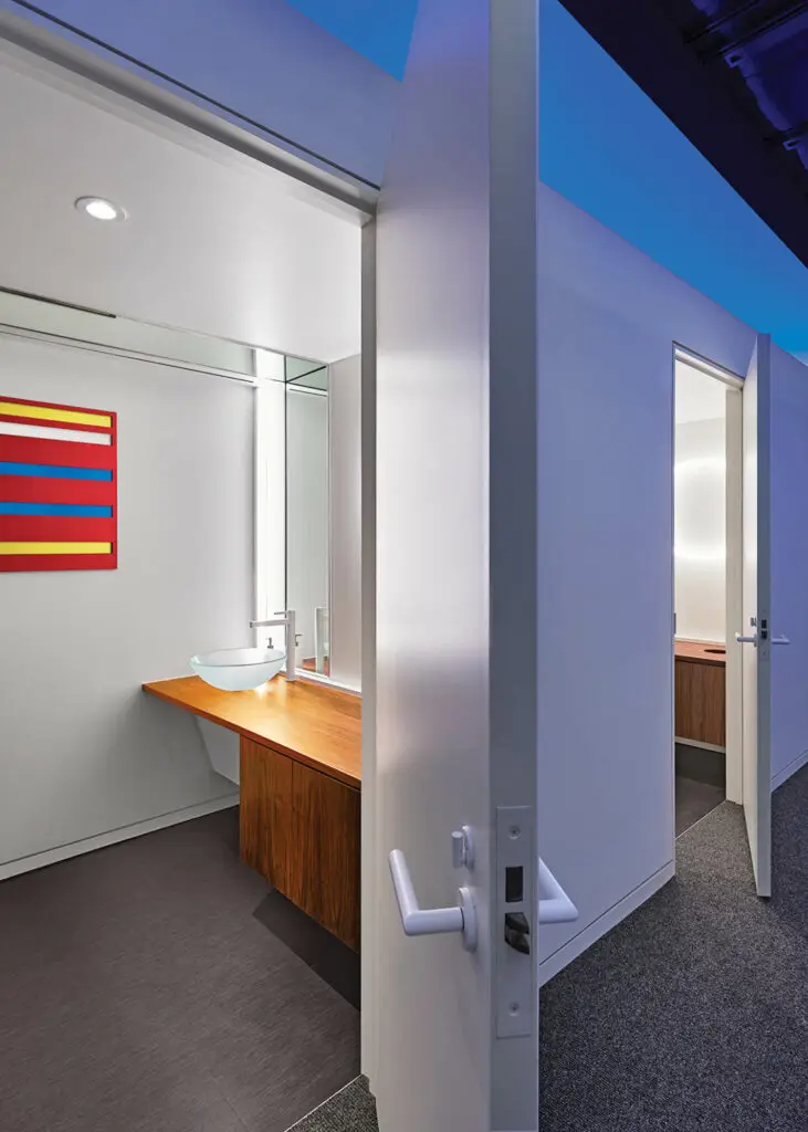 bathroom with white doors and red artwork