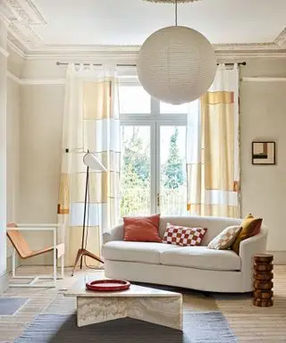 Neutral licing room with curved cream couch