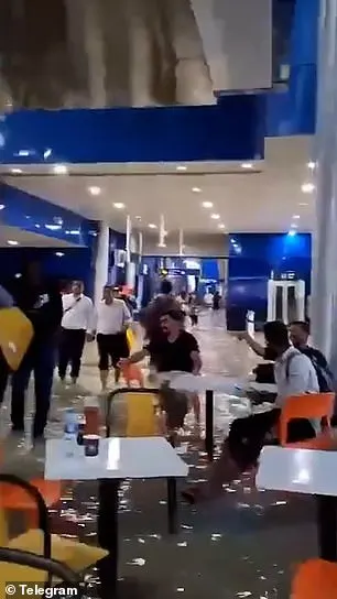 In one clip from Dubai's airport, people are seen wading through ankle-deep water while taking shelter from the brutal weather outside. Some seem almost resigned to the situation, sitting in chairs around tables