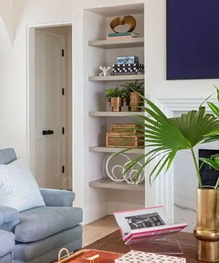 A living room with a tall bookshelf and a coffee table with a vignette