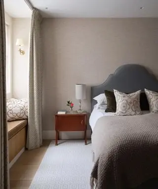 neutral bedroom with light brown walls and gray bedding