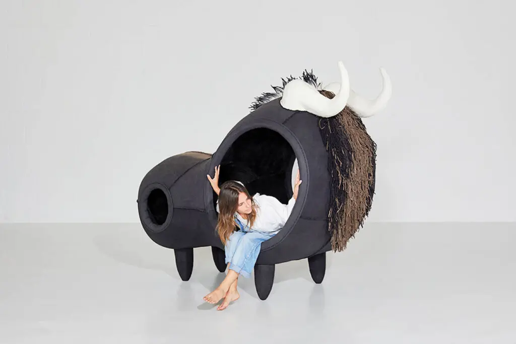 someone coming out of the side of a horned creature