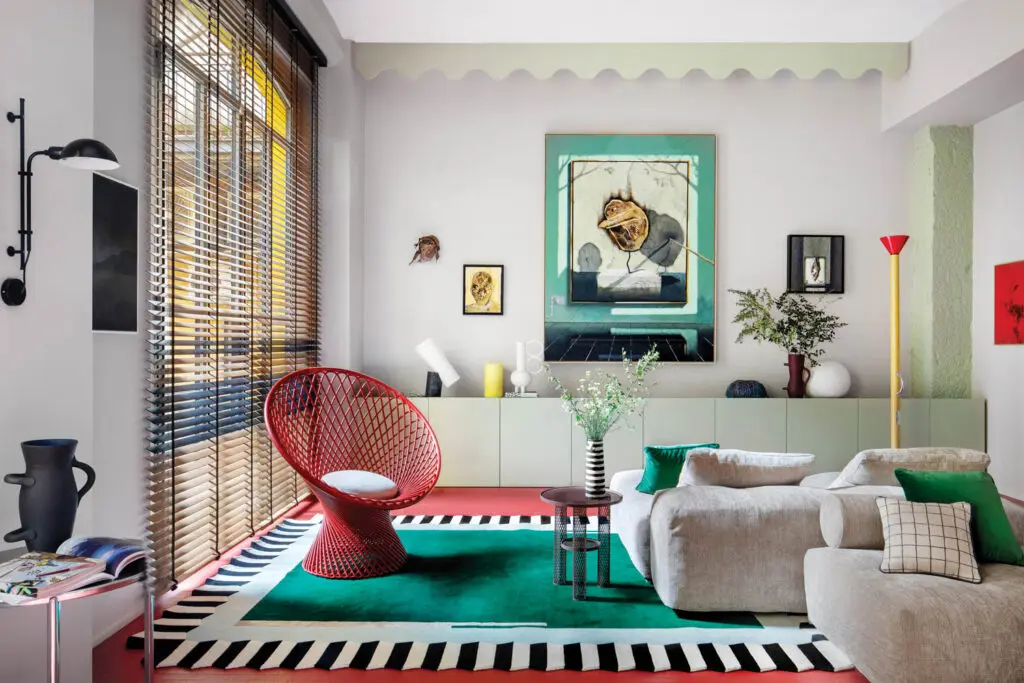 a vibrant living room with a green rug and bold accents