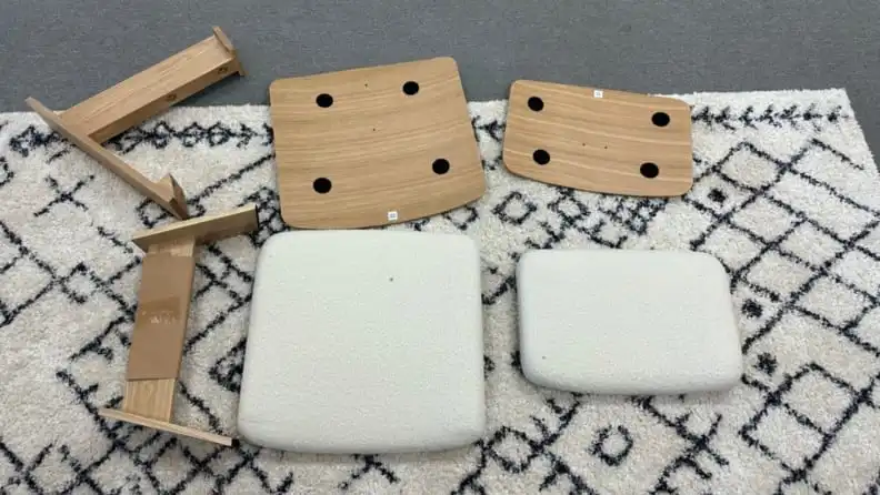 The pieces of the Vela chair laid out on the ground.