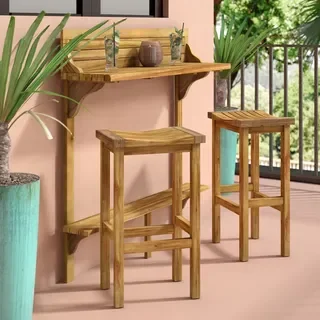 a slimline bar shelf attached to a pink wall with two wooden bar stools