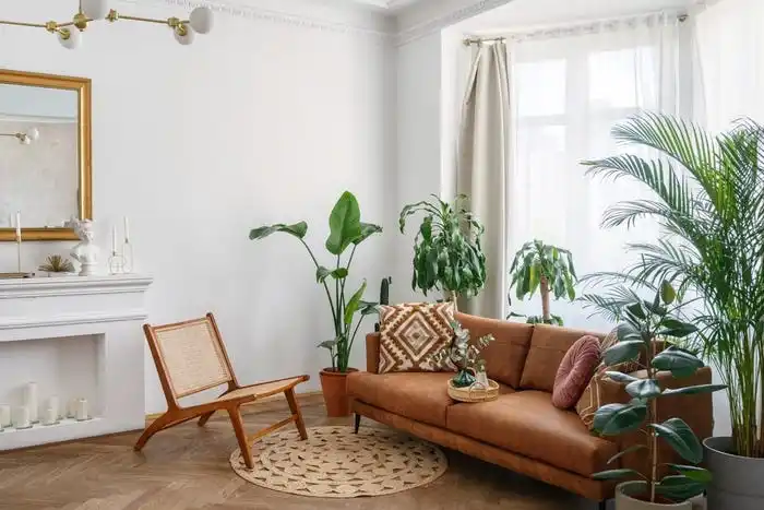 Brown leather couch in front of window