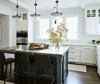 kitchen with white cabinets and blue island