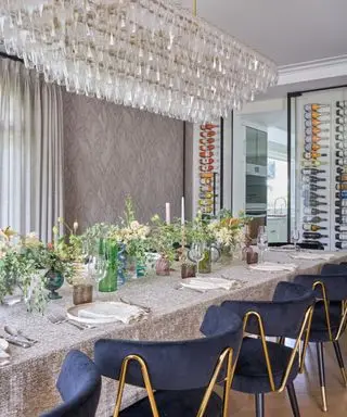 dining room with ornate glass ceiling light blue chairs