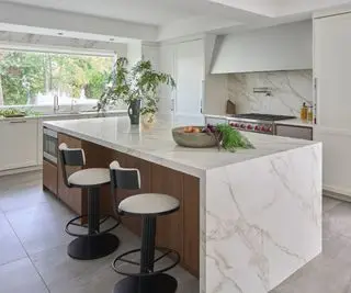 kitchen with marble topped island and wood detail