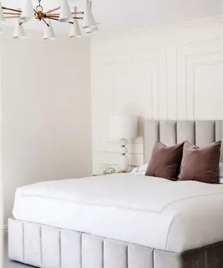 bedroom with cream walls and upholstered headboard