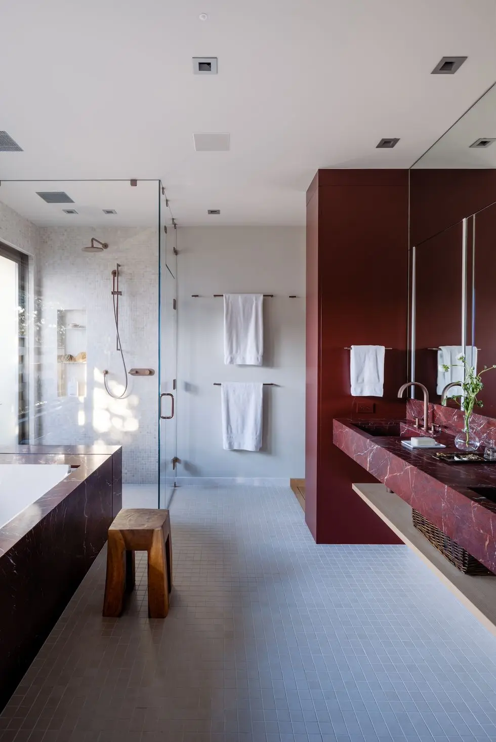 a bathroom with a tub sink and a bench