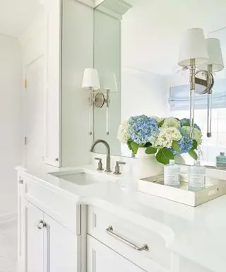 white traditional bathroom with blue flowers on vanity