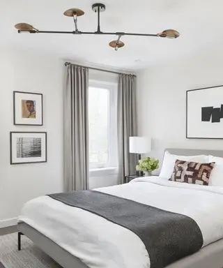 modern white bedroom with gray curtains and black accents