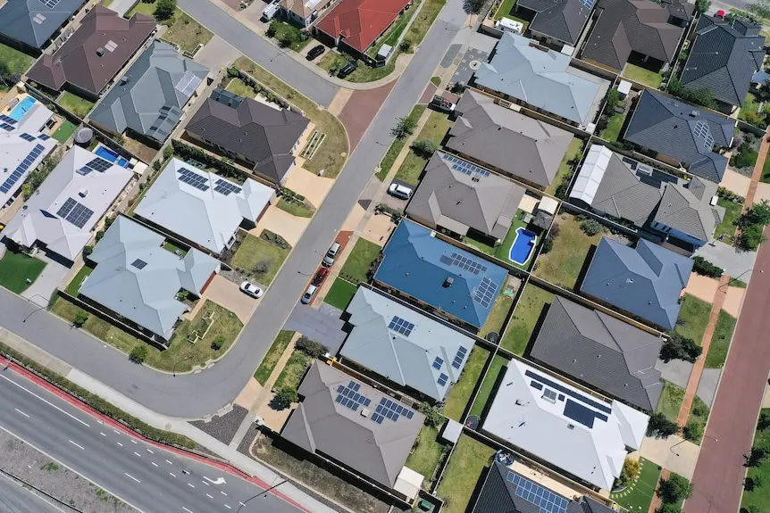 roofs of houses, most of them with solar panels