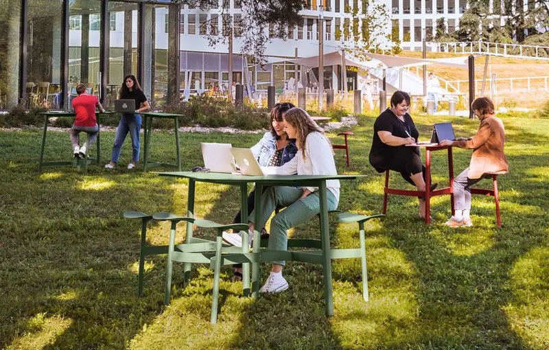 Fermob's Bolder two and three-seater tables with integrated seats, counters and corner connecting tops and high stools in Cactus and Chilli colours at bank Crédit Agricole Centre-est's Terralumia project in Lyon.