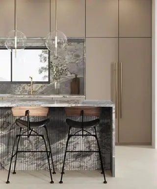 Marble waterfall countertops in a pink kitchen