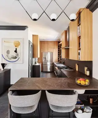 Dark waterfall countertop in a peninsula kitchen