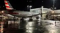 An American Airlines plane sits at a gate at Logan Airport