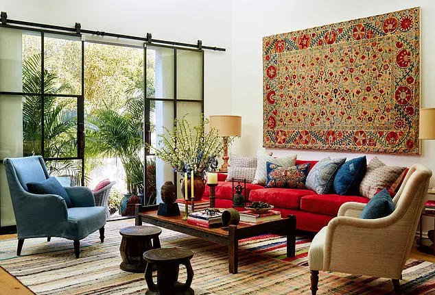 A large antique textile or rug hung on the wall is an ideal way to create a focal point and in this case has informed the colour inspiration of the living room. The coffee table and stools were flea-market finds, while antique seating has a new lease of life, reupholstered in complementary colours and sumptuous fabrics.