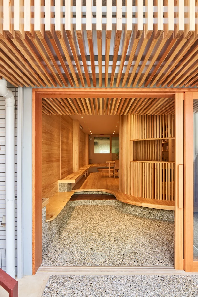 wooden louvers run along kyoto office space's entire interior by ujizono architects