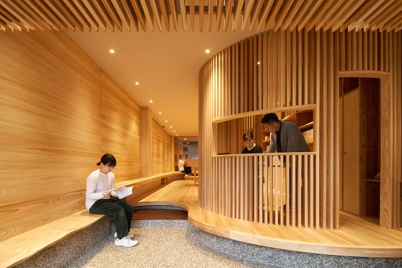 wooden louvers run along kyoto office space's entire interior by ujizono architects