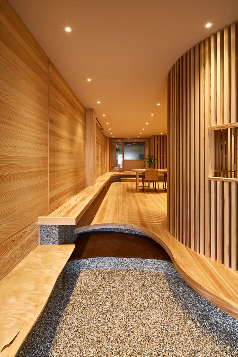 wooden louvers run along kyoto office space's entire interior by ujizono architects