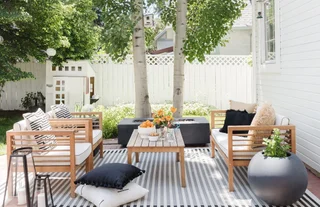 Outdoor compact sofa opposite two lounge chairs from Havenly