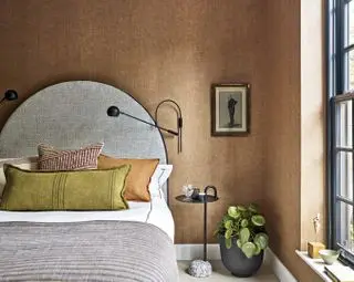 brown bedroom with grey arched headboard and lumbar pillow by Gunter & Co