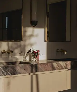 taupe bathroom with marble vanity and accents of brown