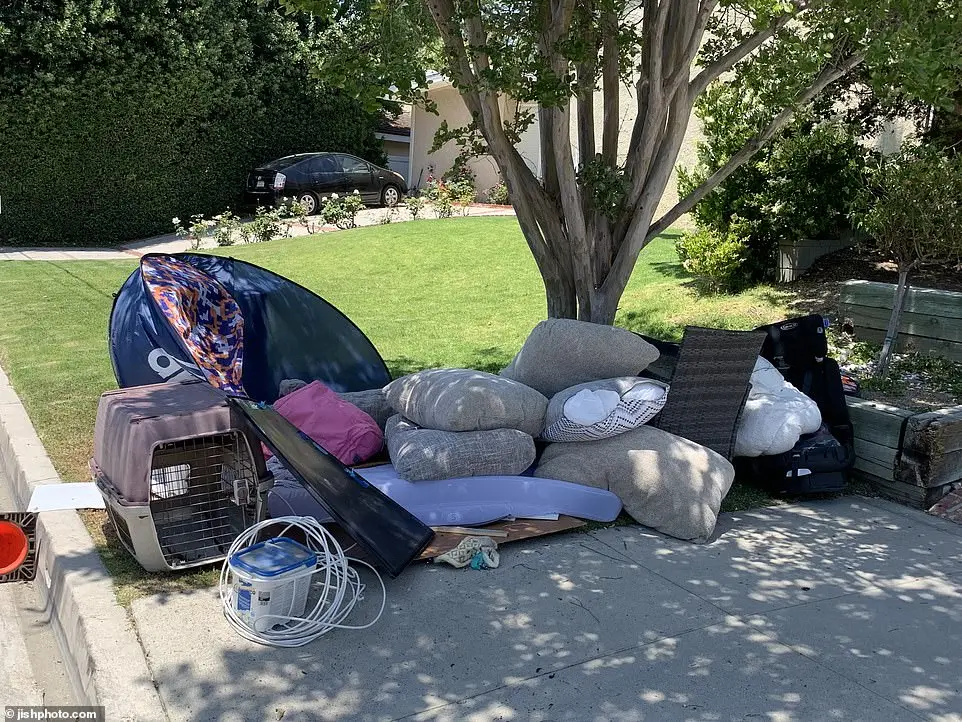 Piles of discarded furniture, cushions, other household items from the home were strewn outside on the otherwise well-kept residential street