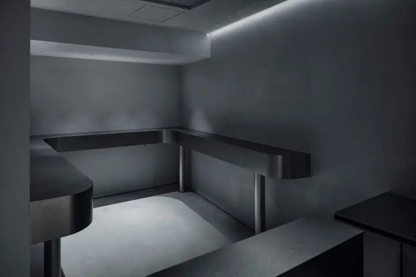 Small seating area with black benches and bars