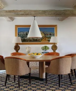 dining room with white pendant light and pattern carpet