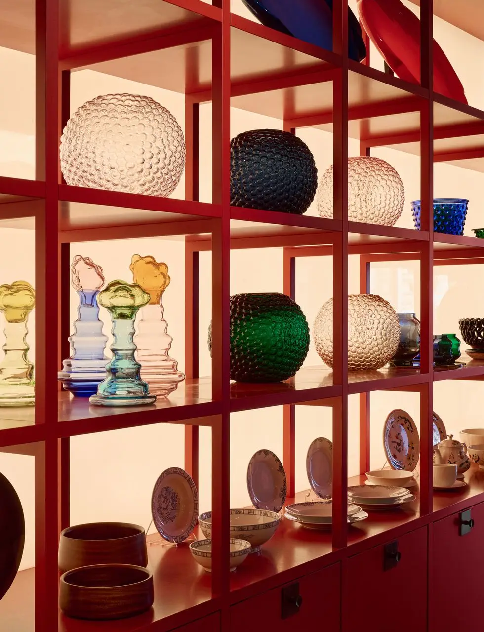 a shelf with many vases and bowls on it