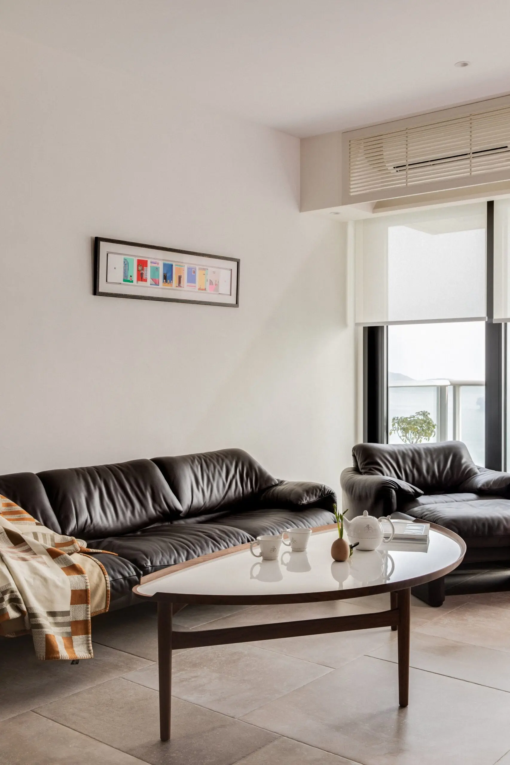 The living room contains a 15-year-old Maralunga sofa, designed by Vico Magistretti for Cassina (cassina.com) in the 1970s. Photo: Harold de Puymorin image