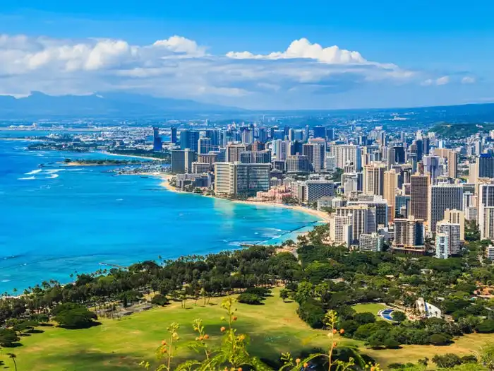 Skyline of a city next to the ocean.