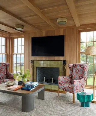 living room with coffee table fireplace and armchair and tv