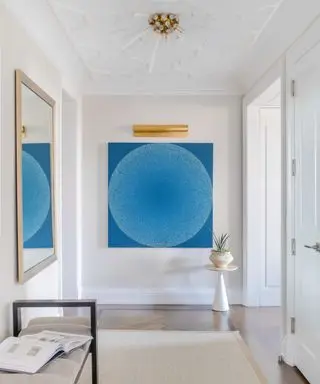 White entryway with large blue artwork