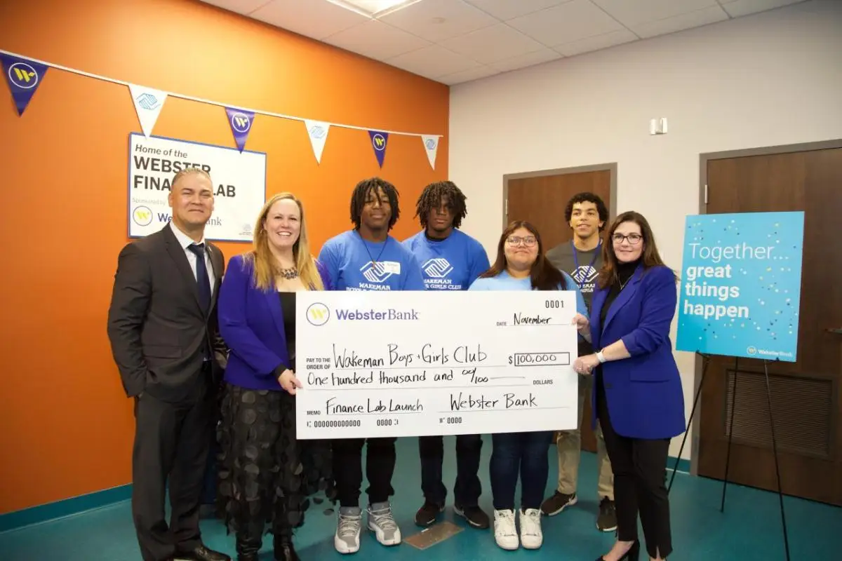 Group celebrating with oversized check