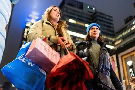 two women, one with big shopping bags