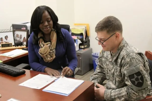 Spc. Mason Steill gets financial assistance from Frederica Norman, a financial advisor at the Soldier and Family Assistance Center on Joint Base Lewis-McChord, Wash.