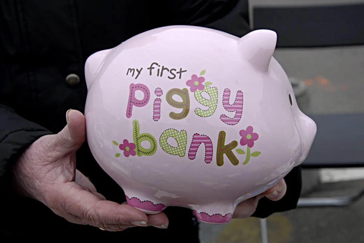 Female holding children my first piggy bank