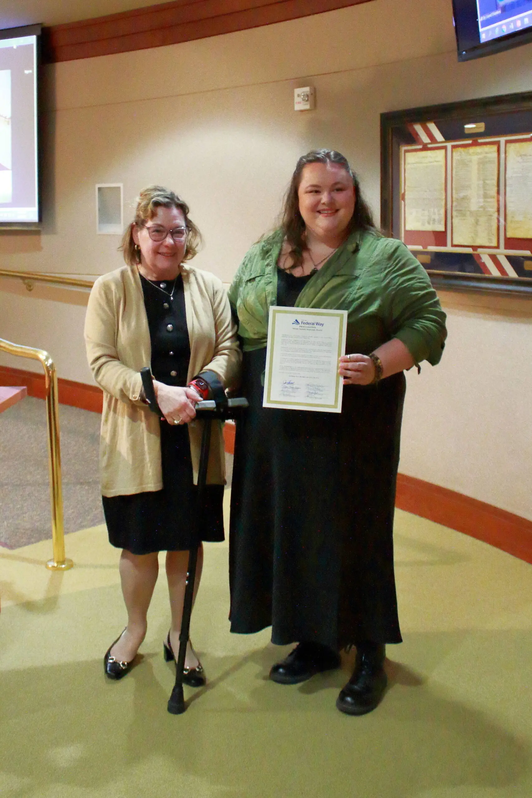 Susan Honda and Haley Lampman of the King County Sexual Assault Resource Center after she received the proclamation for Sexual Assault Awareness Month.