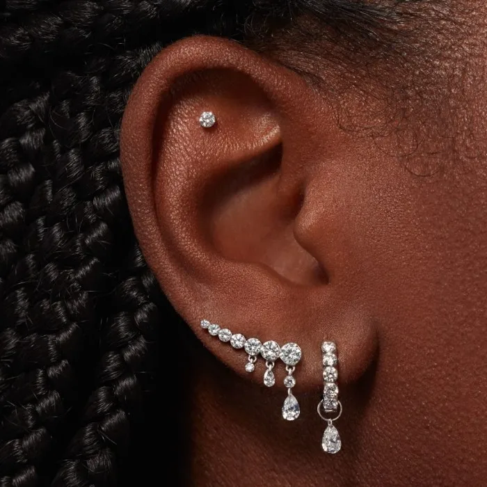 From left: Maria Tash Invisible Set Diamond Threaded stud earring, £225, Eternity hoop earring, £985, Pear Floating Diamond charm, £915, and Invisible Set Diamond Crescendo Bar Threaded stud earring, £4,190