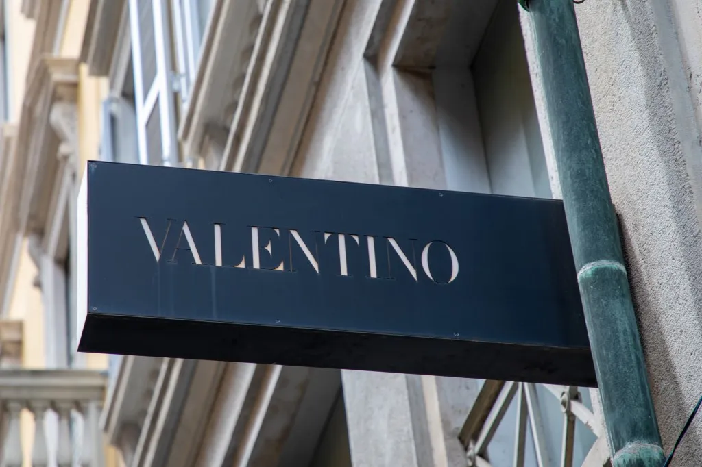 Valentino logo brand and sign text on the facade of its luxury fashion store in Milan, Italy, taken on July 10, 2023