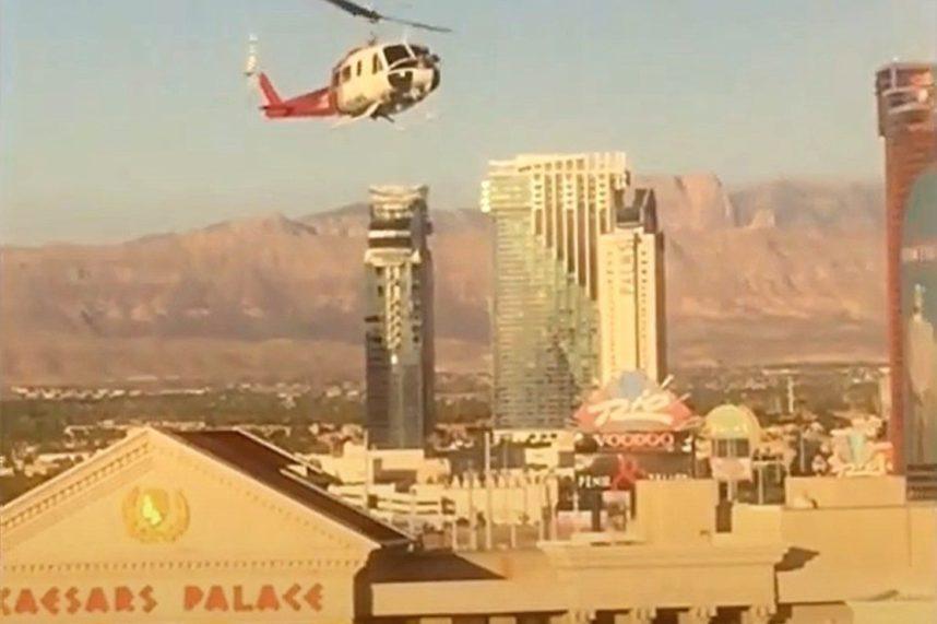 A helicopter hovers over Caesars Palace