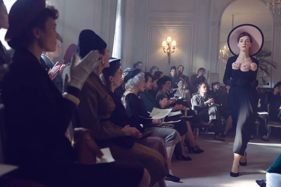 a person standing in front of a group of people sitting in chairs