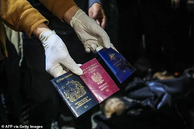 A man displays British, Polish, and Australian passports next to the bodies of the aid workers