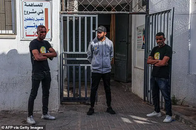 Staff members of the US-based aid group World Central Kitchen wait at a hospital morgue in Rafah in the southern Gaza Strip on April 2, 2024 after the convoy was hit the day before