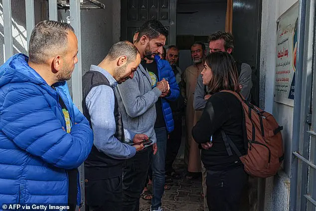 Staff members of the US-based aid group WCK wait at a hospital morgue in Rafah yesterday